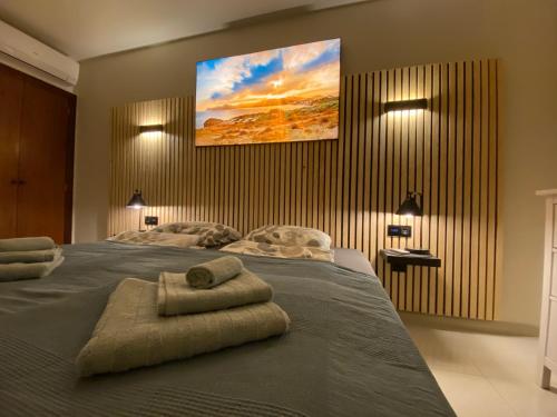 een slaapkamer met een groot bed en handdoeken bij Vivir La Vida in Cala Ratjada