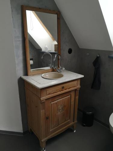 a bathroom with a sink and a mirror at Møllehusets Bed & Breakfast in Nordborg