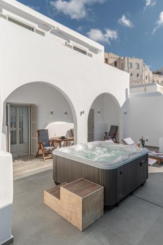 a hot tub on the roof of a building at Mariet Naxos Elegant Suites in Naxos Chora