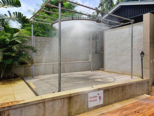 a tennis court inside of a building at Pushpam Sanskruti Resort Karjat- Pure Veg in Karjat