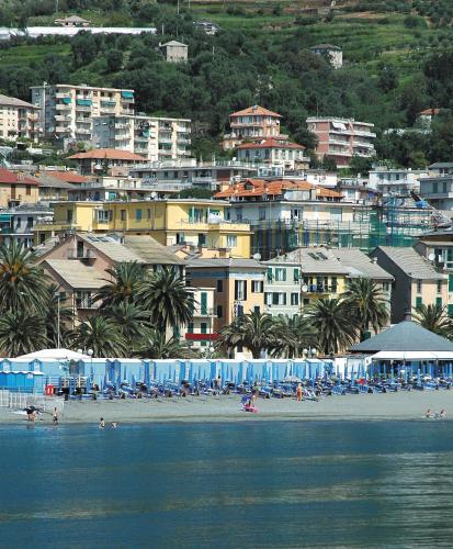 a group of people on a beach with buildings at Hotel Riviera in Arenzano
