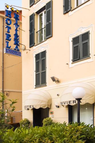 a building with black windows and a sign on it at Hotel Riviera in Arenzano