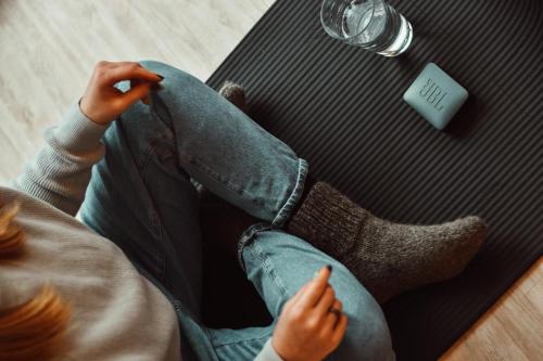 a person sitting in front of a laptop with their legs crossed at Poilsio nameliai - B E L A I K O in Kretinga