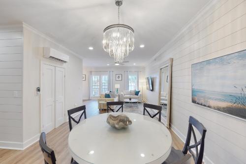 a dining room with a white table and chairs at Village of South Walton EB210 in Rosemary Beach