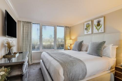 a bedroom with a large bed with a large window at Marco Beach Ocean Resort 607 in Marco Island