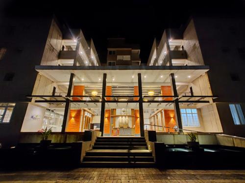 a building with stairs in front of it at night at Pushpam Sanskruti Resort Karjat- Pure Veg in Karjat