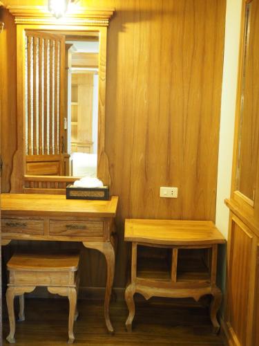 a bathroom with a dressing table and a mirror at Rich Lanna House in Chiang Mai