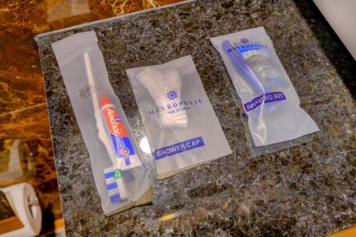 a group of toothbrushes and toothpaste on a counter at Metropolis Business Hotel in Panaji