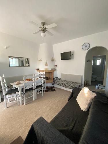 a living room with a couch and a table at Molos Sea View House - Paros Greece in Molos Parou