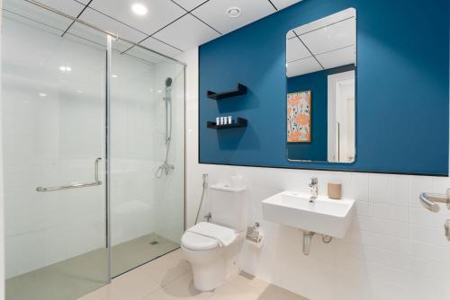 a bathroom with a toilet and a shower and a sink at Lux BnB Nook -2 I City Views in Dubai