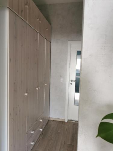 a room with wooden cabinets and a hallway at Ferienwohnung Luise mit separater Küche in Naumburg