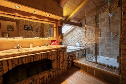 a bathroom with two sinks and a shower at Magic Megève Bois in Demi-Quartier