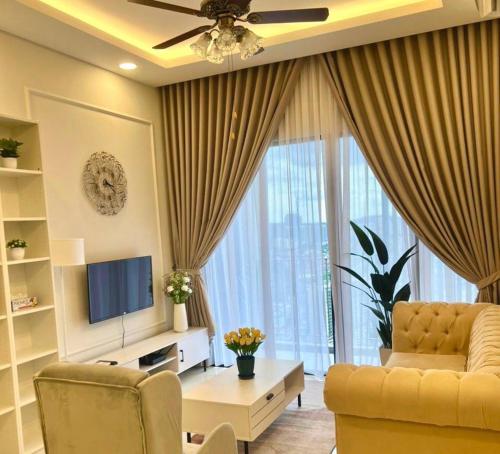 a living room with a couch and a television at Millerz Suite 3R2B Condo Near MidValley 3 Beds 3 Bedrooms Staycation Best Choice in Kuala Lumpur