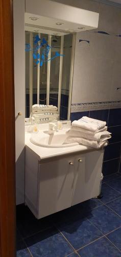 a bathroom with a white sink and a mirror at Chambre d'hôtes un petit coin de paradis en Corrèze in Laguenne