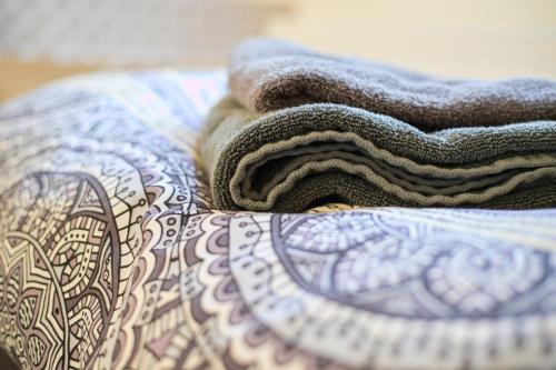 a towel is sitting on top of a bed at Haus Rheinsheimer Scheuer in Philippsburg