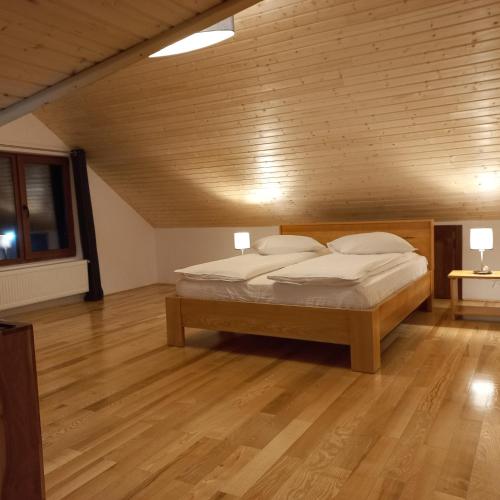 a bedroom with a bed in a room with wooden floors at Cedra in Predeal