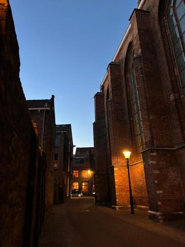 an alley with a street light next to a building at Monkey Tree Stay in Schiedam