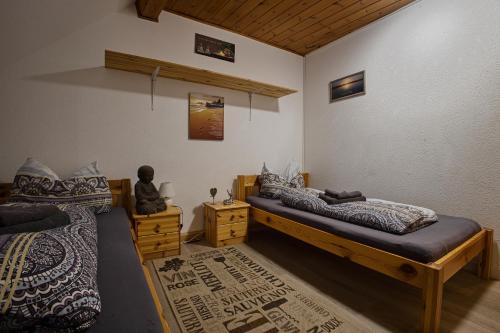 a bedroom with two beds and a statue in it at Haus Rheinsheimer Scheuer in Philippsburg