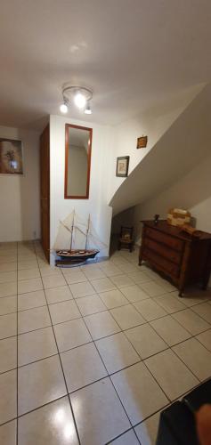 a room with a staircase with a boat on the wall at Chambre d'hôtes un petit coin de paradis en Corrèze in Laguenne