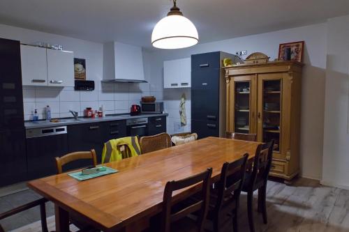 a kitchen with a wooden table and some chairs at Haus Rheinsheimer Scheuer in Philippsburg