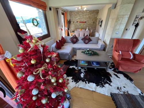 a living room with a christmas tree and a couch at Villa Dream Arachova in Arachova