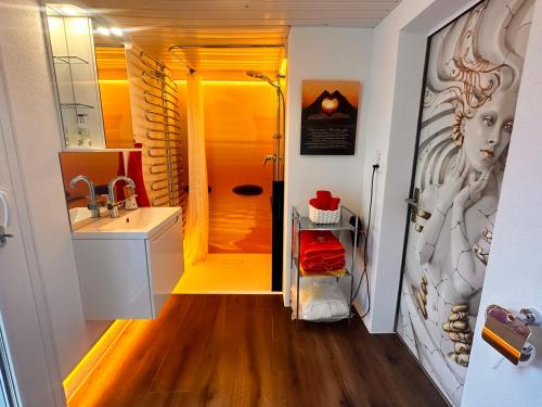 a bathroom with a sink and a shower at Bijouswiss " Yellow House" in Oberterzen