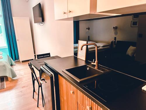 a kitchen with a sink and a counter top at Supreme Apartment in the City Center in Kraków