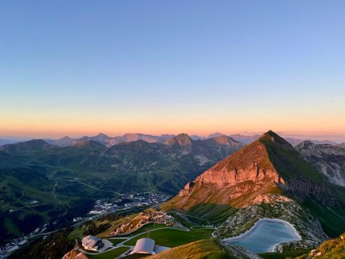 a view from the top of a mountain with a lake at Hotel Binggl in Obertauern