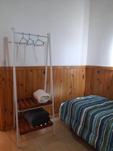 1 dormitorio con cama y estante junto a la cama en Aires de Trevelin en Trevelín