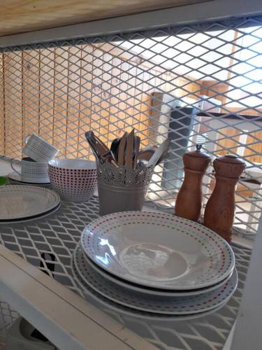 a table with plates and utensils on a shelf at Aires de Trevelin in Trevelin