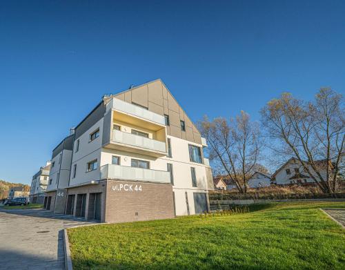 a white building with a sign on the side of it at Apartament w Cieplicach Panorama in Jelenia Góra