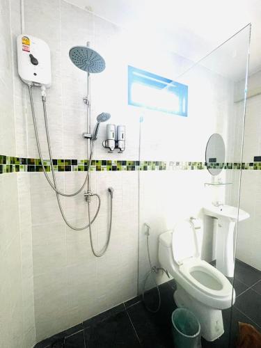 a bathroom with a shower and a toilet at Baan Purada in Ko Lanta