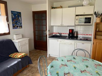 een keuken met een bank en een tafel in een kamer bij Chalet Pastel in Morillon