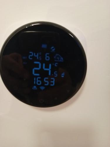 a black alarm clock sitting on top of a table at MONADIN Villa Relax & Spa in Săcele