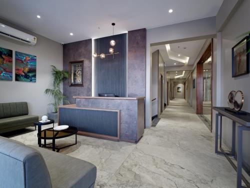 a lobby with a reception desk in a building at Hotel Akruti, Nanded in Nānded