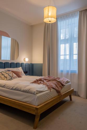 a bedroom with a bed and a large window at Willa Zalesie in Krynica Zdrój