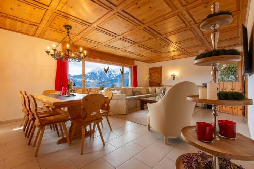 Chalet Casa Acla Laax في لاكس: غرفة طعام وغرفة معيشة مع طاولة وكراسي