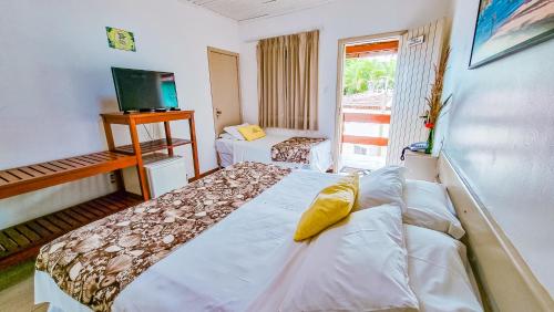 Cama ou camas em um quarto em Pousada Portal da Concha