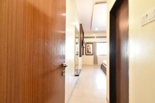 a door leading into a hallway with a hallway at Hotel Sai Sparsh in Shirdi