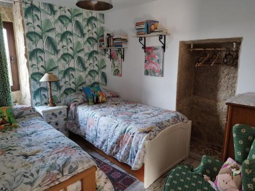 a bedroom with two beds and a chair at Casa Rural Area con piscina in Gondomar