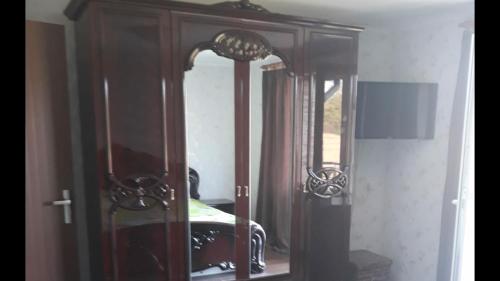 a dresser with a mirror in a bedroom at Vila Adrian Argeș in Vedea
