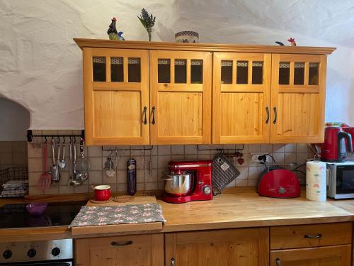 a kitchen with wooden cabinets and a counter top at Jurahaus Hirschberg EG Wohnung in Beilngries