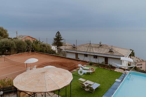 an aerial view of a house with a tennis court at Sea Home above Sori village in Sori