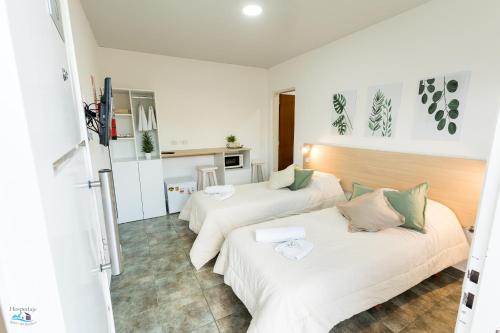 a hotel room with two beds and a kitchen at APART HOTEL RIBERA DEL BARADERO pileta climatizada in Baradero