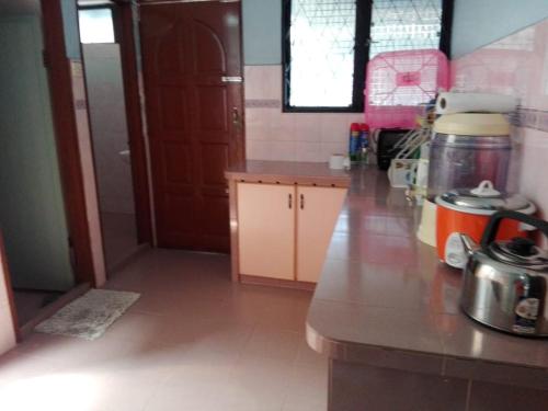 a kitchen with a counter and a counter top at Idaman guesthouse Malay only in Kubang Semang