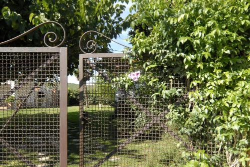 a metal fence with a tree in the background at MAS PALOL in Viladamat