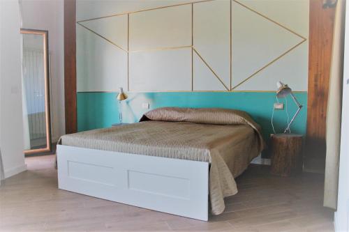 a bedroom with a bed with a large headboard at Bora B&B in Troia
