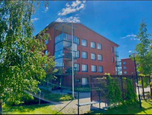 a red brick building with a bench in front of it at Cozy Aparment with sauna nearby Airport in Vantaa