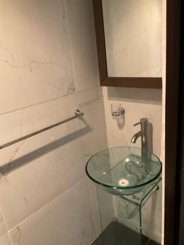 a bathroom with a glass sink and a shower at Almendra in Mexico City