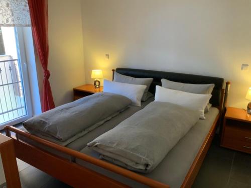 a bed with two pillows on it in a room at Kaeppler-Hof-Wieners in Olsberg